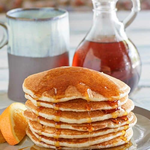 Copycat IHOP country griddle cakes topped with syrup on a plate.