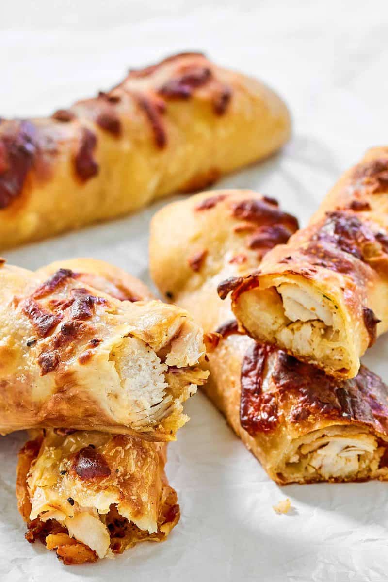 Several copycat Costco chicken bakes on parchment paper.