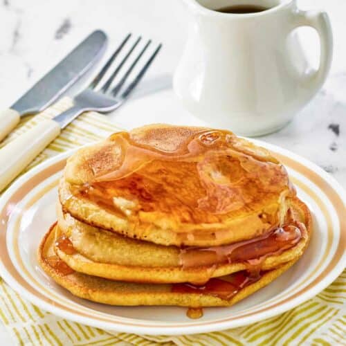 Copycat McDonald's pancakes with buttery maple syrup on a plate.