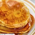 Homemade McDonald's hotcakes with syrup on a plate.