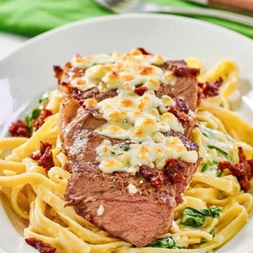 Copycat Olive Garden steak gorgonzola alfredo on a platter.