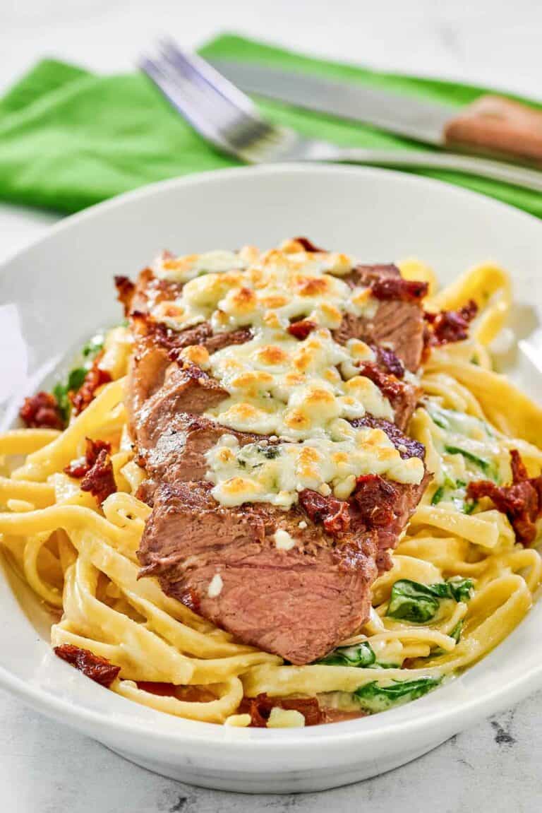 Copycat Olive Garden steak gorgonzola alfredo on a platter.