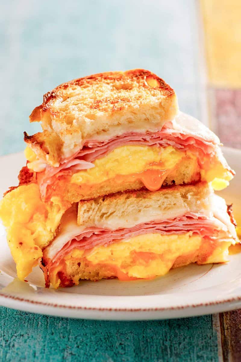 Copycat Denny's moons over my hammy breakfast sandwich halves stacked on a plate.