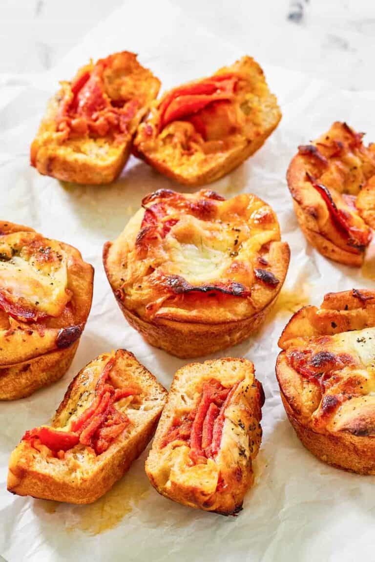 Copycat Little Caesars crazy puffs with pepperoni on parchment paper.