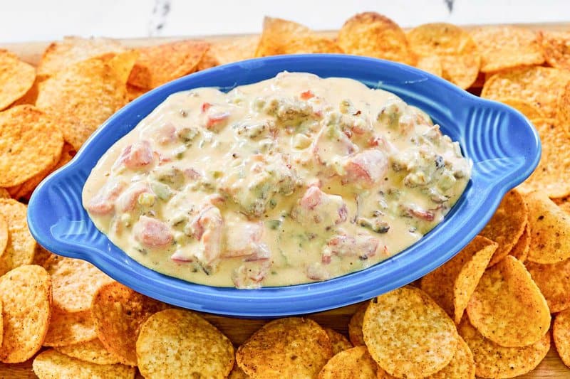 Of course! Here are the alt text descriptions for the Rotel sausage dip images.
For Rotel-Sausage-Cream-Cheese-Dip-Ingredients-768x512.jpg:
An overhead shot of the ingredients for Rotel sausage dip on a parchment-lined baking sheet. Pictured are a block of raw ground sausage, cream cheese, sliced Velveeta cheese, and bowls of Rotel tomatoes, sour cream, and pickled jalapenos.
For Rotel-Sausage-Cream-Cheese-Dip-Recipe-Steps-Collage-768x1152.jpg:
A six-panel collage showing the steps to make sausage Rotel dip. The first three panels show Velveeta and cream cheese being melted and mixed with Rotel tomatoes. The next panels show cooked sausage being added to the cheese mixture, with the final image showing the finished dip in a slow cooker.
For Rotel-Sausage-Cream-Cheese-Dip-Photo-1-768x512.jpg:
A blue oval dish filled with creamy Rotel sausage dip, showing chunks of tomato and sausage in the cheesy base. The dish sits on a wooden board and is surrounded by a generous amount of seasoned tortilla chips.