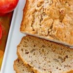 Homemade apple bread loaf with slices cut from it.