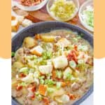 A bowl of cheeseburger soup and garnishes in small bowls.