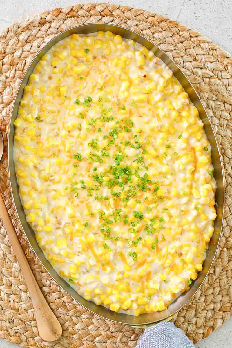 Cheesy creamed corn in a large copper skillet.