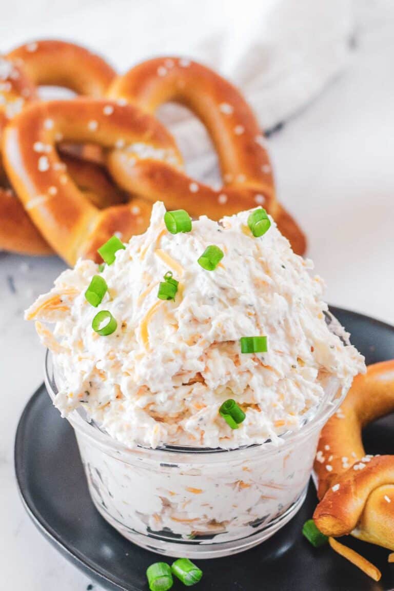 Cold beer cheese dip and soft pretzels behind it.
