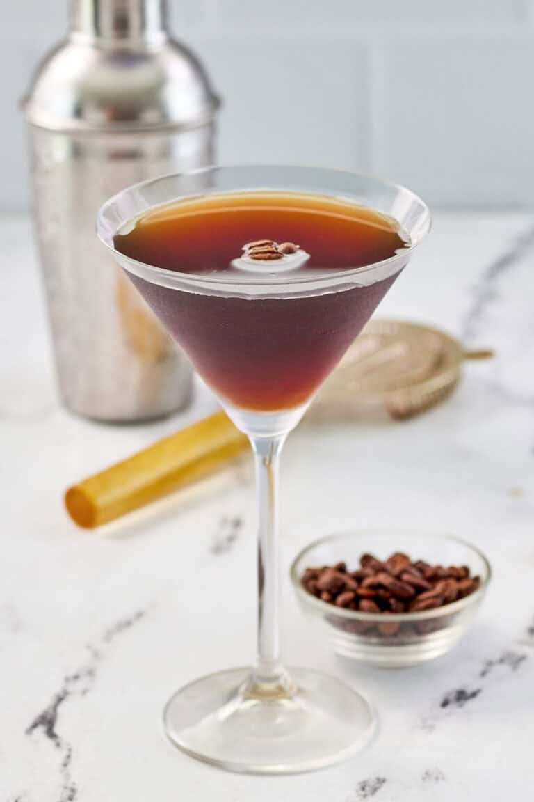 Copycat chili's espresso martini and a small bowl of espresso coffee beans.