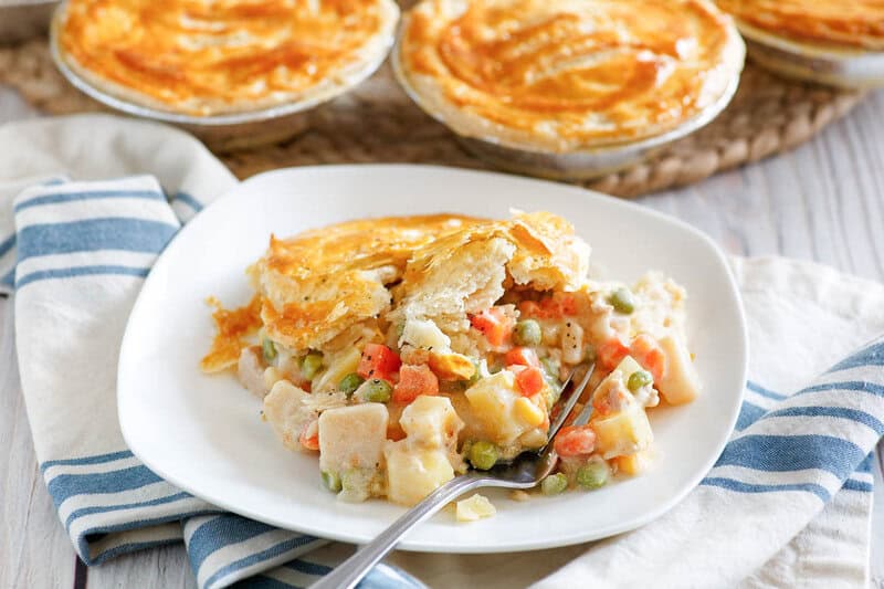 Copycat KFC chicken pot pie and a fork on a plate.