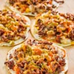 Homemade taco villa mexican pizzas on a wood platter.