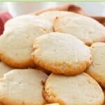 Homemade cream cheese cookies in a basket lined with a kitchen towel.