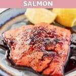 Homemade Cheddar's bourbon glazed salmon and lemon wedges on a plate.
