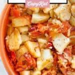 Crockpot cheesy potatoes in a ceramic bowl.