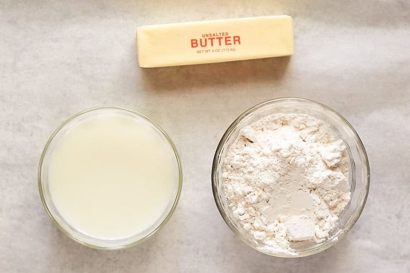 Copycat Popeyes biscuits ingredients on parchment paper.