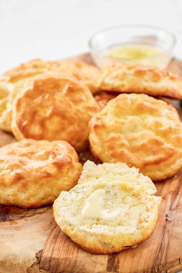 Copycat Popeyes biscuits on a wood board.