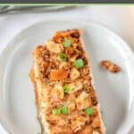 Air fryer salmon almondine garnished with green onions.