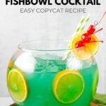 Homemade Bennigan's paddy o' punch fishbowl cocktail on a wood board.