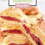 Three corned beef breakfast sandwiches on a wood board.