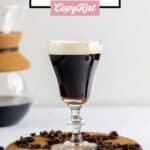Traditional Irish coffee and coffee beans on a wood board.