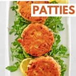 Three old-fashioned salmon patties on a platter.