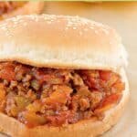 A homemade sloppy joe sandwich on parchment paper.