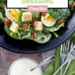 A bowl of copycat Commander's Palace salad dressing and a salad beside it.