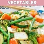 Homemade Panda Express mixed vegetables and chopsticks on a plate.