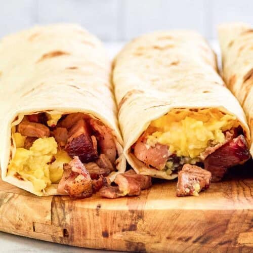 Two copycat Buc-ee's egg and smoked brisket breakfast tacos.