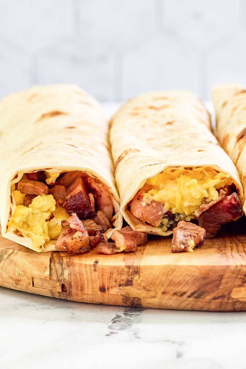 Two copycat Buc-ee's egg and smoked brisket breakfast tacos.