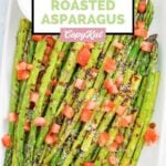 Homemade olive garden parmesan roasted asparagus and a cup of dipping sauce.