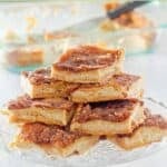 Homemade sopapilla cheesecake slices on a cake stand.