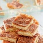 Homemade sopapilla cheesecake bars on a cake stand.