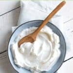 A small bowl of sweetened yogurt on top of a cloth napkin.