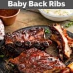 Homemade Claim Jumper ribs on a plate and a cup of bbq sauce.