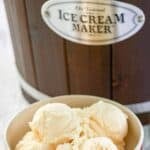 A bowl of homemade French vanilla ice cream and an ice cream maker.