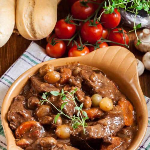 Homemade Julia Child beef bourguignon, bread, tomatoes, and mushrooms.