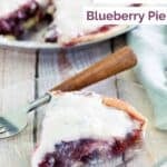 A slice of homemade Marie Callender's sour cream blueberry pie on a small plate.