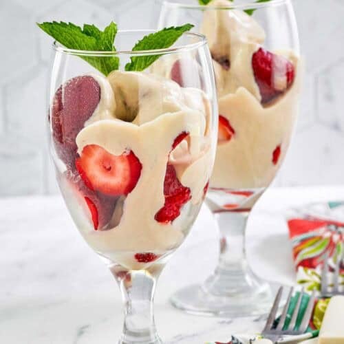 Copycat La Madeleine strawberries romanoff in wine glasses.