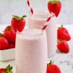 Homemade strawberry juilus in two glasses and fresh strawberries.