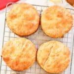 Six homemade Bojangles biscuits on a wire rack.
