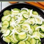 Cucumber onion salad on a round platter.