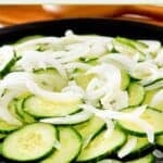 Cucumber onion salad on a platter.
