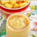 Homemade dole whip with rum float next to a bowl of pineapple chunks.
