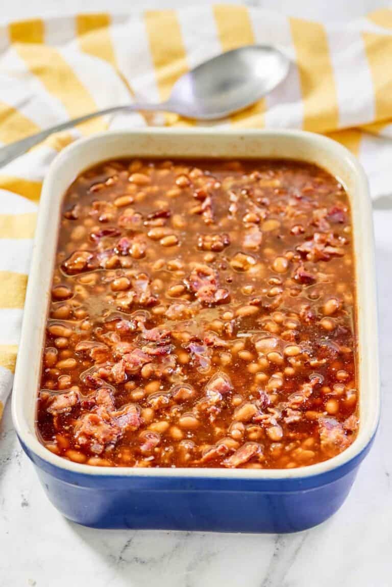Copycat Durgin Park Boston baked beans and a serving spoon behind it.