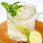 Homemade mojito and a lime next to it.