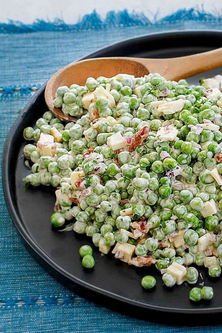 Pea salad with bacon and cheese on a plate.