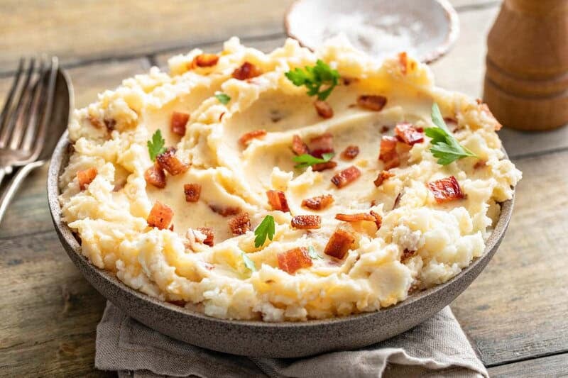 Copycat Ponderosa Steakhouse loaded mashed potatoes in a serving bowl.