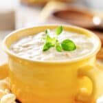 A bowl of homemade Sweet Tomatoes clam chowder on a plate.
